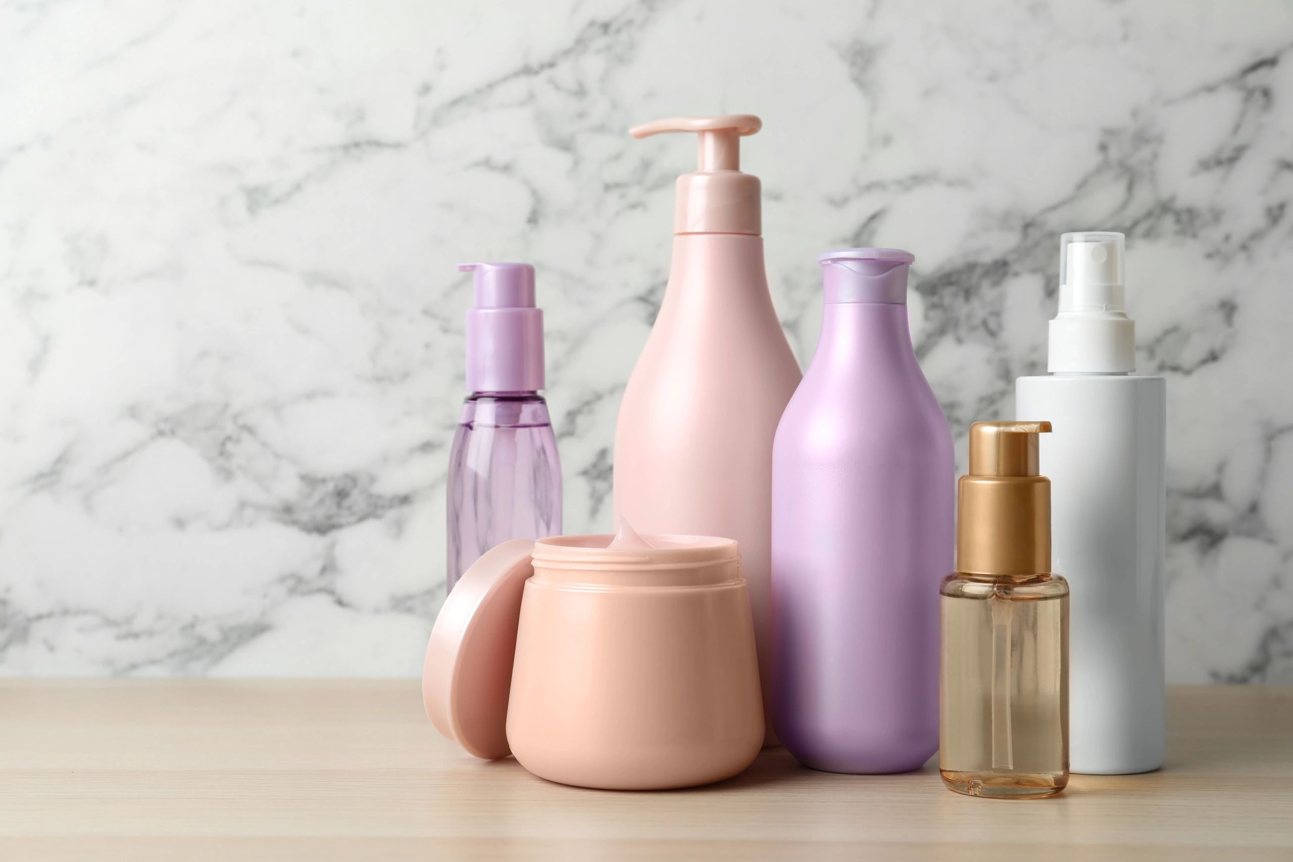 Selection of gentle, safe hair care products displayed on a wooden table.