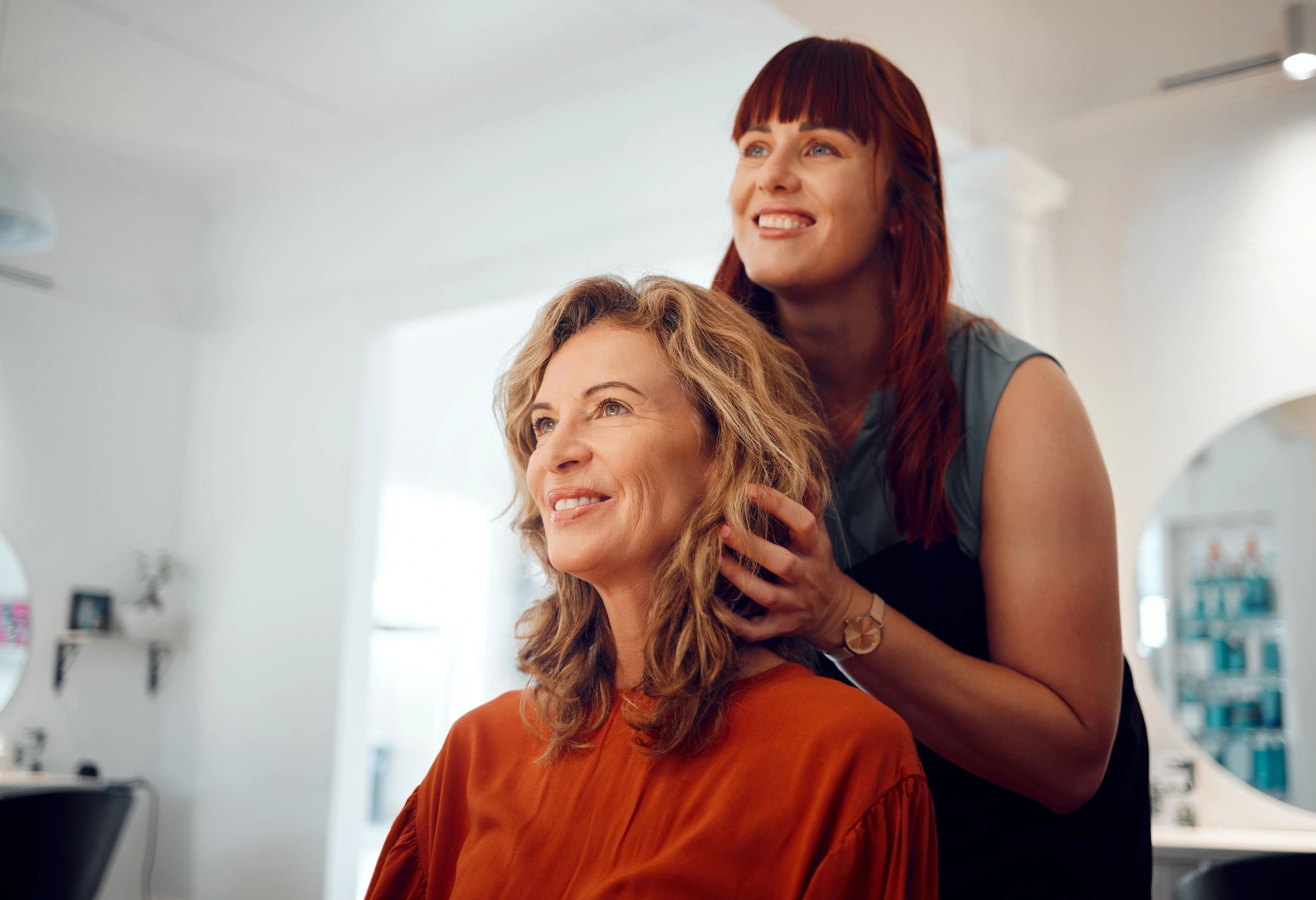 Stylist consulting with a senior client, highlighting personal attention and care.